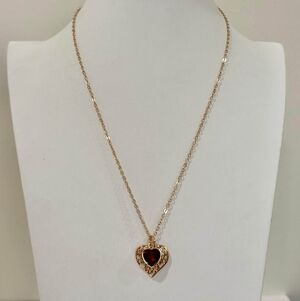Jewelry Fine Gold tone necklace features a red heart-shaped pendant. 6 g. 18"